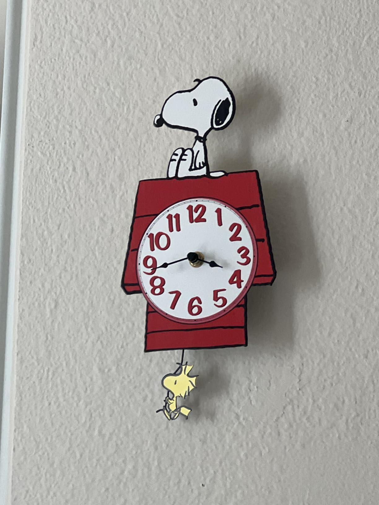 Mark Feldstein Peanuts Snoopy Doghouse Pendulum Wall Clock, 12 in | Officially licensed collectible; stamped metal; keyhole mount; 1 AA battery not included; ships in protective packaging customer photo 1