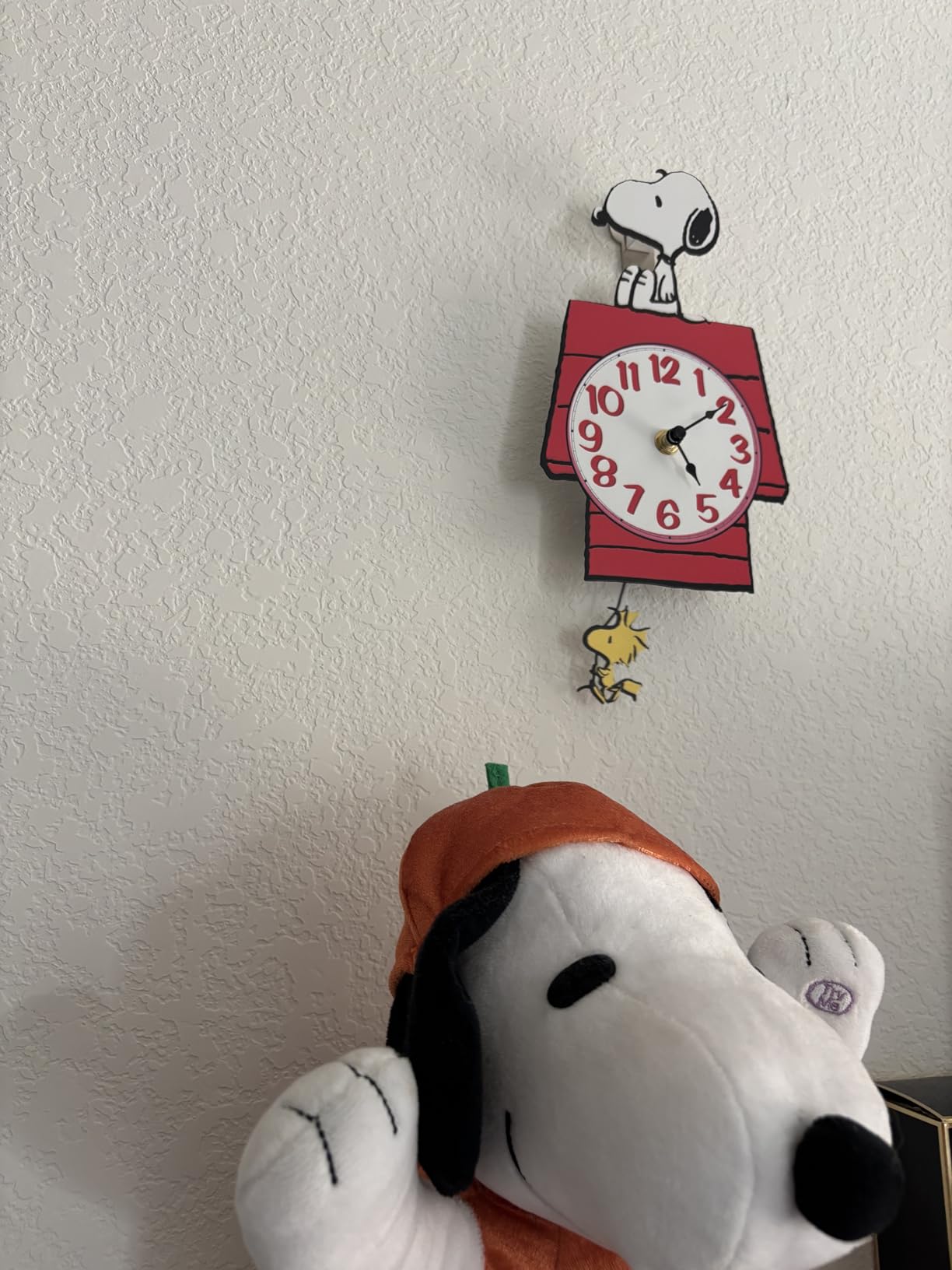Mark Feldstein Peanuts Snoopy Doghouse Pendulum Wall Clock, 12 in | Officially licensed collectible; stamped metal; keyhole mount; 1 AA battery not included; ships in protective packaging customer photo 2